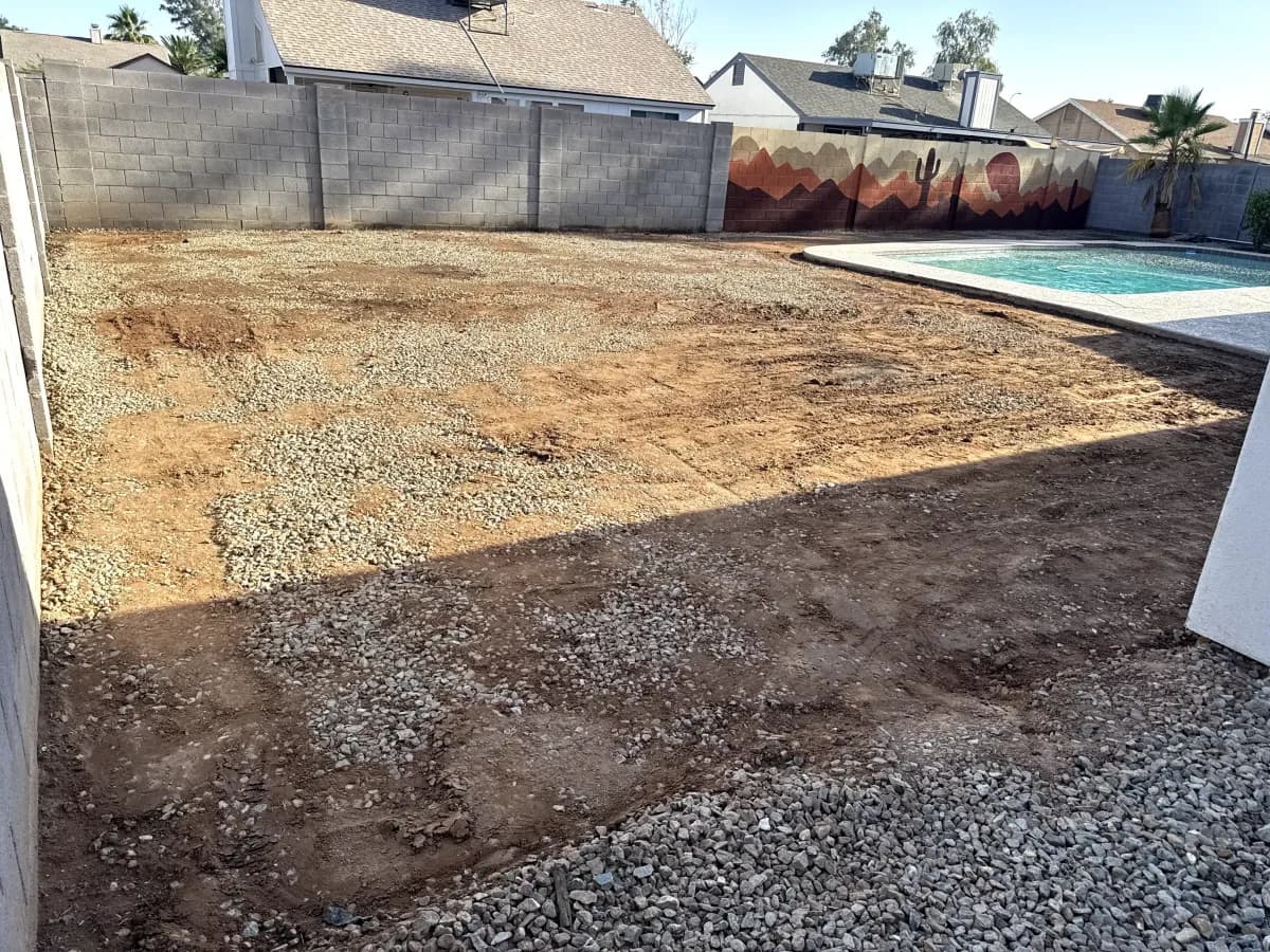 Backyard dirt lot before remodeling, beside an existing pool